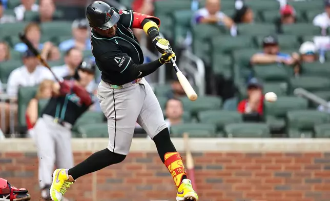 Arizona Diamondbacks' Geraldo Perdomo hits a single in the first inning of a baseball game against the Atlanta Braves, Friday, Aug. 14, 2026, in Atlanta. (AP Photo/Colin Hubbard)