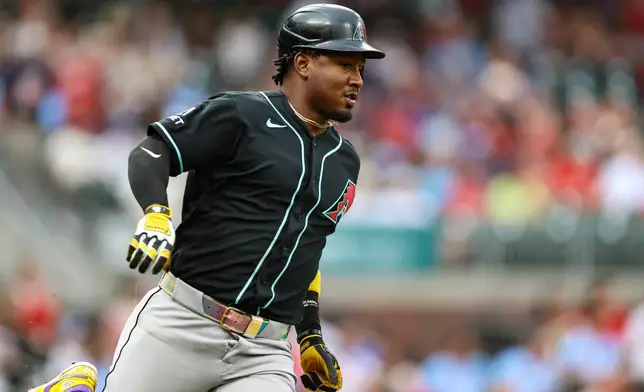 Arizona Diamondbacks' Geraldo Perdomo runs to first base after hitting a single in the first inning of a baseball game against the Atlanta Braves, Friday, Aug. 14, 2026, in Atlanta. (AP Photo/Colin Hubbard)