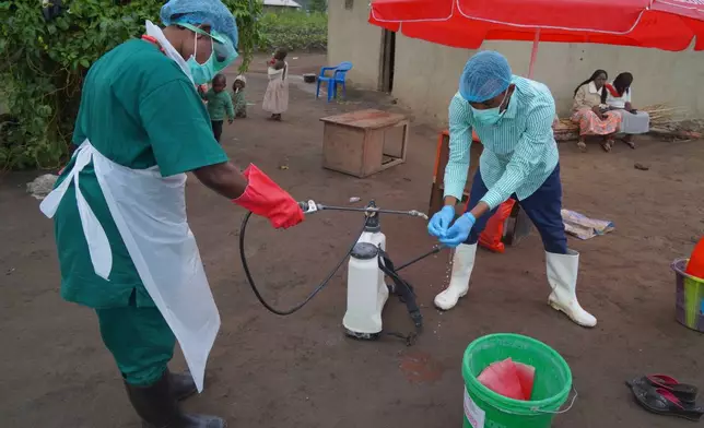 Wiza Bondele, Right, a health worker on the prevention and control team, seen at work in Ituri province, eastern Congo, Wednesday, Aug 5, 2026. (AP Photo/Dieudonne Dirole)