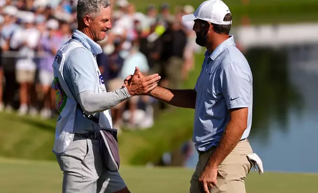 Scottie Scheffler celebrates winning on the 18th green the final round of the St. Jude Championship golf tournament, Sunday, Aug. 16, 2026, in Memphis, Tenn. (AP Photo/George Walker IV)