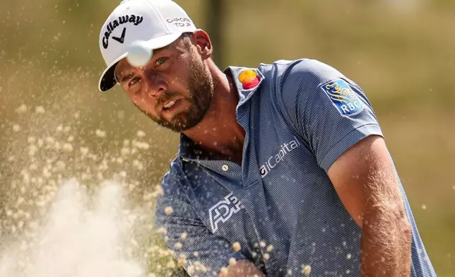 Sam Burns hits from a bunker on the 13th hole during the final round of the St. Jude Championship golf tournament, Sunday, Aug. 16, 2026, in Memphis, Tenn. (AP Photo/George Walker IV)