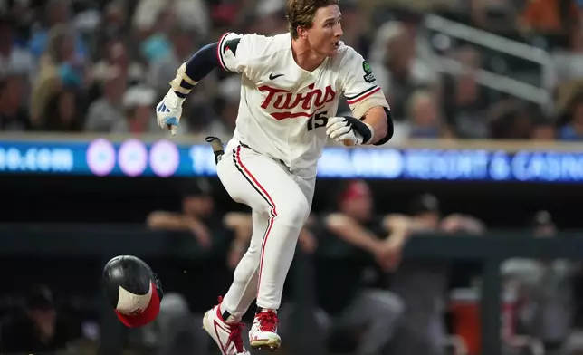 Minnesota Twins' Luke Keaschall runs to first base after hitting a single during the ninth inning of a baseball game against the Chicago White Sox, Friday, Aug. 28, 2026, in Minneapolis. (AP Photo/Ellen Schmidt)