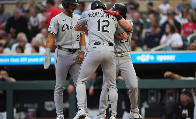 Chicago White Sox' Colson Montgomery (12) celebrates with Braden Montgomery (24) and Andrew Benintendi (23) after his home run during the first inning of a baseball game against the Minnesota Twins, Friday, Aug. 28, 2026, in Minneapolis. (AP Photo/Ellen Schmidt)