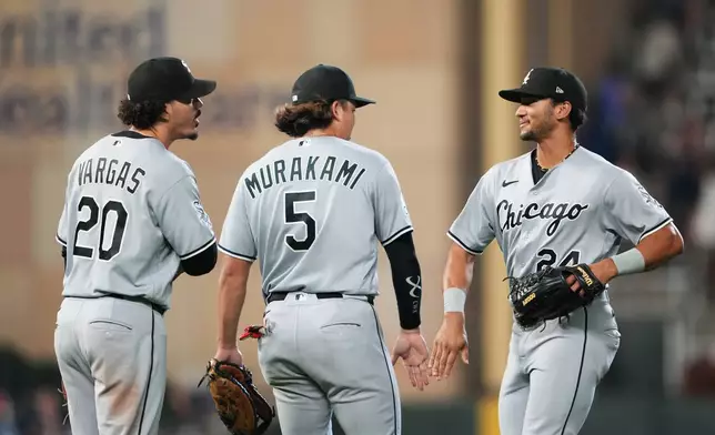 Chicago White Sox third baseman Miguel Vargas (20), first baseman Munetaka Murakami (5) and right fielder Braden Montgomery (24) celebrate after winning a baseball game against the Minnesota Twins, Friday, Aug. 28, 2026, in Minneapolis. (AP Photo/Ellen Schmidt)