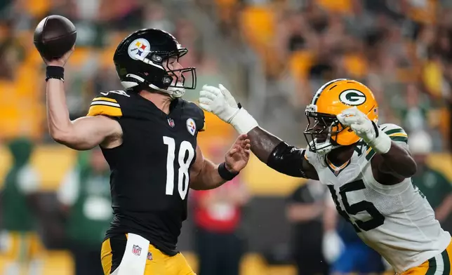 Pittsburgh Steelers quarterback Will Howard (18) throws a pass under pressure from Green Bay Packers defensive end Collin Oliver (45) in the second half of a preseason NFL football game in Pittsburgh, Thursday, Aug. 13, 2026. (AP Photo/Gene J. Puskar)
