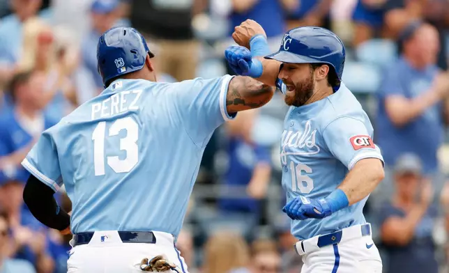 Kansas City Royals' John Rave (16) celebrates after his two-run home run with Salvador Perez (13) during the fifth inning of a baseball game against the Detroit Tigers in Kansas City, Mo., Sunday, Aug. 23, 2026. (AP Photo/Colin E. Braley)