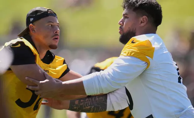 Pittsburgh Steelers linebacker Alex Highsmith (56), left, is blocked by offensive tackle Troy Fautanu during the team's NFL football training camp in Latrobe, Pa., on Friday, July 31, 2026.(AP Photo/Gene J. Puskar)