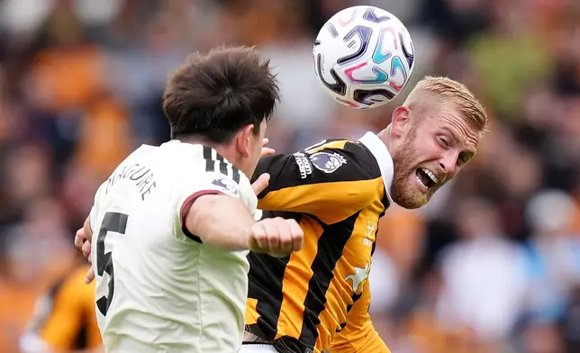 Manchester United's Harry Maguire, left, and Hull City's Oliver McBurnie in action during the English Premier League soccer match between Hull City and Manchester United in Kingston upon Hull, England, Saturday Aug. 22, 2026. (Annabel Lee-Ellis/PA via AP)
