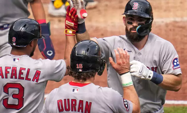 Boston Red Sox's Connor Wong, right, is high-fived by Ceddanne Rafaela (3) and Jarren Duran (16) as he returns to the dugout after hitting a three-run home run off Pittsburgh Pirates pitcher Hunter Barco during the fifth inning of a baseball game in Pittsburgh, Sunday, Aug. 16, 2026. (AP Photo/Gene J. Puskar)
