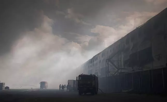 Smoke rises above warehouse stores after a Russian air attack in Kyiv, Ukraine, Thursday, Aug. 27, 2026. (AP Photo/Efrem Lukatsky)