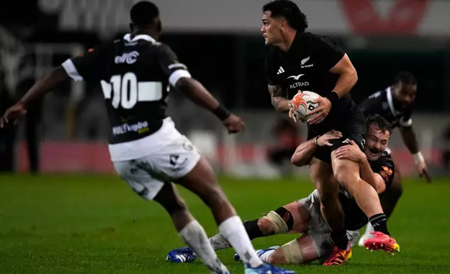 Sharks' Nick Hatton, right, tackles All Blacks' Quinn Tupaea during a friendly rugby match between Sharks and All Blacks, in Durban, South Africa, Tuesday, Aug. 11, 2026. (AP Photo/Themba Hadebe)