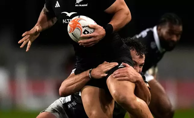 Sharks' Nick Hatton, right, tackles All Blacks' Quinn Tupaea during a friendly rugby match between Sharks and All Blacks, in Durban, South Africa, Tuesday, Aug. 11, 2026. (AP Photo/Themba Hadebe)