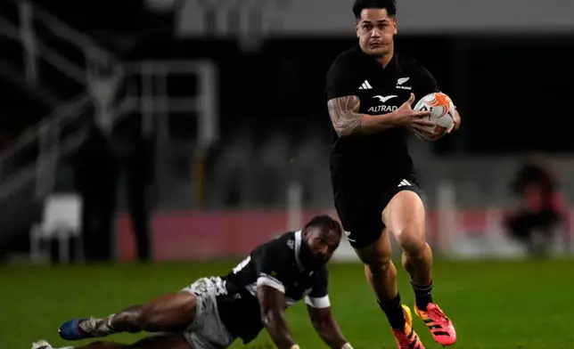 All Blacks' Quinn Tupaea, right, breaks away from Sharks' Jurenzo Julius during a friendly rugby match between Sharks and All Blacks, in Durban, South Africa, Tuesday, Aug. 11, 2026. (AP Photo/Themba Hadebe)