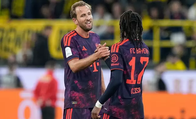 Bayern's Harry Kane, left, and Michael Olise celebrates after winning the Franz Beckenbauer German Supercup soccer match against Borussia Dortmund in Dortmund, Germany, Saturday, Aug. 22, 2026. (AP Photo/Martin Meissner)