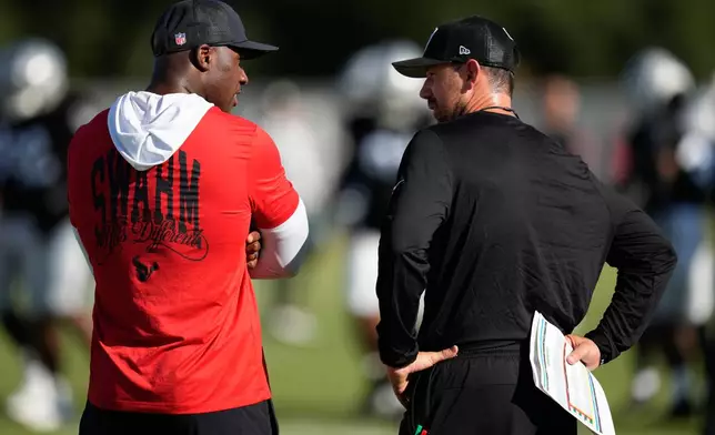 Houston Texans head coach DeMeco Ryans, left, talks with Las Vegas Raiders head coach Klint Kubiak during a joint practice at the NFL football training camp Tuesday, Aug. 18, 2026, in Houston. (AP Photo/Ashley Landis)