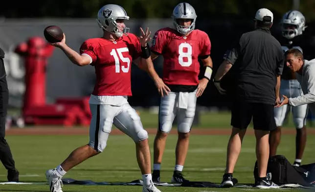 Las Vegas Raiders quarterback Fernando Mendoza (15) and quarterback Kirk Cousins (8) work out during a joint practice with the Houston Texans at the NFL football training camp Tuesday, Aug. 18, 2026, in Houston. (AP Photo/Ashley Landis)