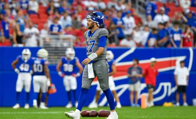 Buffalo Bills quarterback Josh Allen (17) walks on the field during practice at the team's NFL football training camp Saturday, Aug. 8, 2026, in Orchard Park, N.Y. (AP Photo/Adrian Kraus)