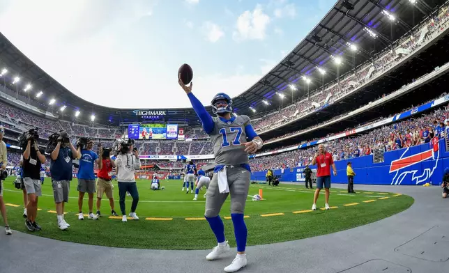 Buffalo Bills quarterback Josh Allen (17) plays catch with fans during practice at the team's NFL football training camp Saturday, Aug. 8, 2026, in Orchard Park, N.Y. (AP Photo/Adrian Kraus)