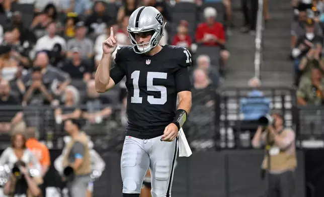 Las Vegas Raiders quarterback Fernando Mendoza (15) pauses on the field during the first half of a preseason NFL football game against the Arizona Cardinals, Thursday, Aug. 13, 2026, in Las Vegas. (AP Photo/David Becker)