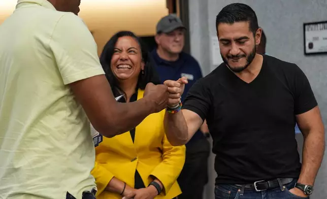 Abdul El-Sayed, right, a progressive candidate in the Democratic primary for U.S. Senate in Michigan, accompanied by Rep. Analilia Mejia, D-N.J., greets a supporter during a campaign rally at the UAW Region 1 Union Hall, Sunday, Aug. 2, 2026, in Warren, Mich. (AP Photo/Julia Demaree Nikhinson)