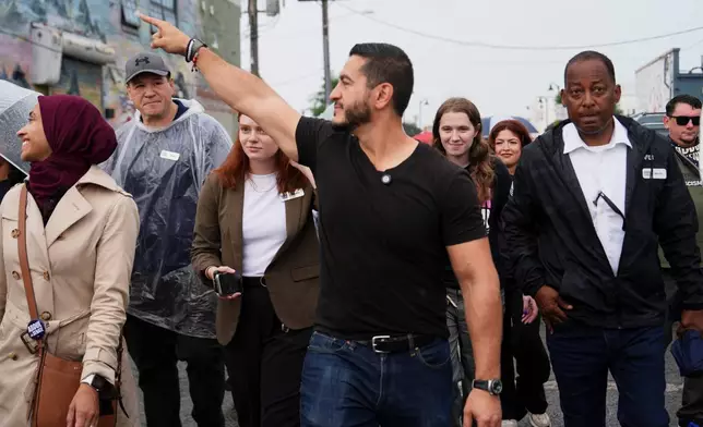Abdul El-Sayed, a progressive candidate in the Democratic primary for U.S. Senate in Michigan, walks from Anthology Coffee to the Spirit of Detroit during the March of the Many, Sunday, Aug. 2, 2026, in Detroit. (AP Photo/Julia Demaree Nikhinson)