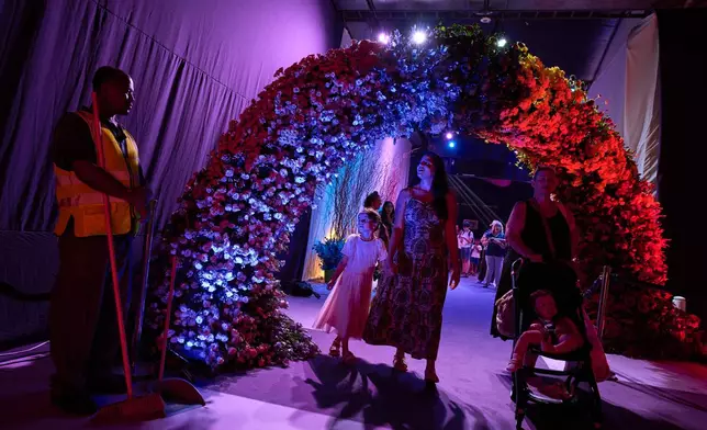 People visit the flower exhibition in Tel Aviv, Israel, Thursday, Aug. 13, 2026. (AP Photo/Oded Balilty)