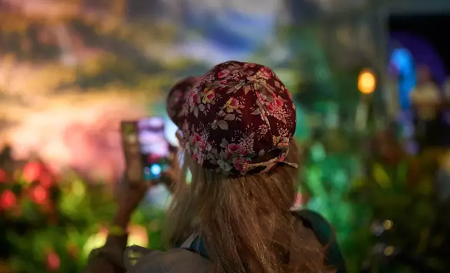 People visit the flower exhibition in Tel Aviv, Israel, Thursday, Aug. 13, 2026. (AP Photo/Oded Balilty)