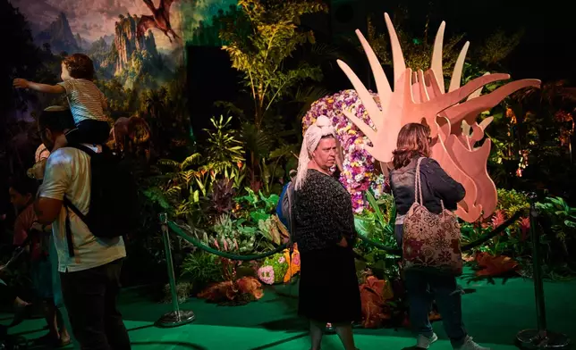 People visit the flower exhibition in Tel Aviv, Israel, Thursday, Aug. 13, 2026. (AP Photo/Oded Balilty)