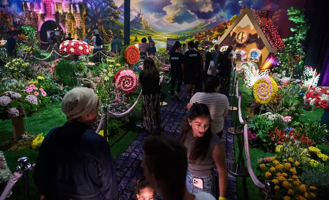 People visit the flower exhibition in Tel Aviv, Israel, Thursday, Aug. 13, 2026. (AP Photo/Oded Balilty)