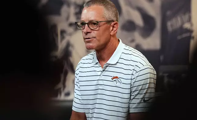 Denver Broncos co-owner and chief executive officer Greg Penner talks to reporters at the team's NFL football training camp in Centennial, Colo., Tuesday, Aug. 11, 2026. (AP Photo/David Zalubowski)