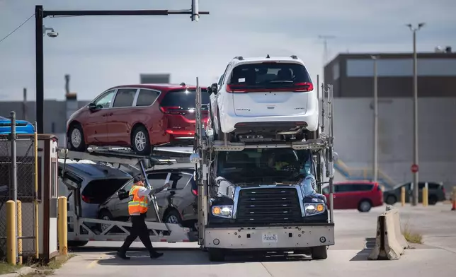 A transport truck carrying Chrysler Pacificas leaves the Windsor Assembly Plant, in Windsor, Ontario, Canada, on Monday, Aug. 24, 2026. (Dax Melmer/The Canadian Press via AP)
