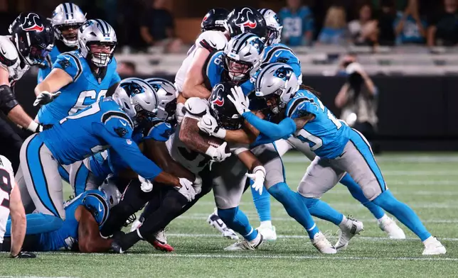 Houston Texans running back Deuce Vaughn is tackled by the Carolina Panthers during the second half of an NFL preseason football game, Friday, Aug. 28, 2026, in Charlotte, N.C. (AP Photo/Scott Kinser)