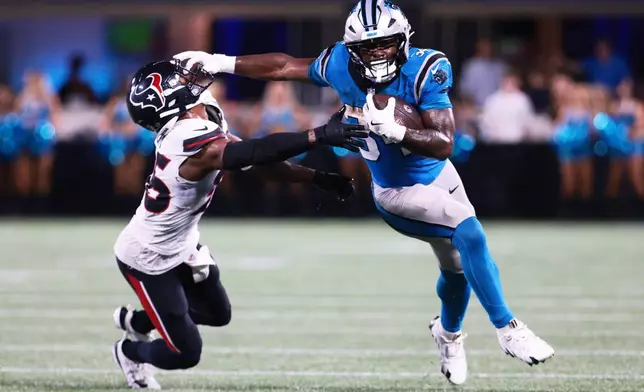 Carolina Panthers running back Anthony Tyus III runs past Houston Texans' George Odum during the second half of an NFL preseason football game, Friday, Aug. 28, 2026, in Charlotte, N.C. (AP Photo/Scott Kinser)