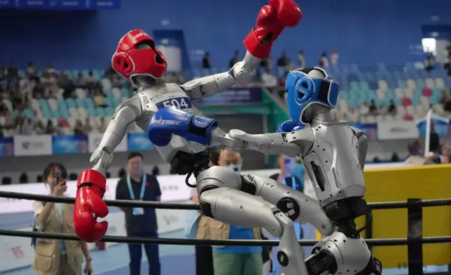 Robots compete at the Free Combat event of the World Humanoid Robot Games in Beijing, Sunday, Aug. 23, 2026. (AP Photo/Achmad Ibrahim)