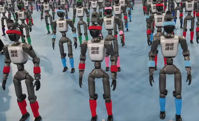 Robots are prepared ahead the opening ceremony of the World Humanoid Robot Games in Beijing, Saturday, Aug. 22, 2026. (AP Photo/Achmad Ibrahim)
