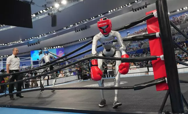 Robots compete at the Free Combat event of the World Humanoid Robot Games in Beijing, Sunday, Aug. 23, 2026. (AP Photo/Achmad Ibrahim)