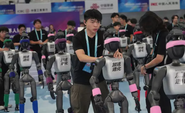 Robots are prepared ahead the opening ceremony of the World Humanoid Robot Games in Beijing, Saturday, Aug. 22, 2026. (AP Photo/Achmad Ibrahim)