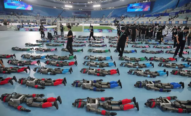 Robots are prepared ahead the opening ceremony of the World Humanoid Robot Games in Beijing, Saturday, Aug. 22, 2026. (AP Photo/Achmad Ibrahim)
