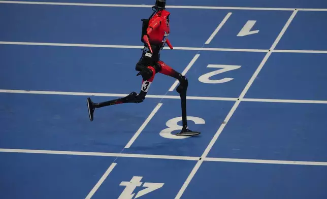 A robot competes in the 1500m during the World Humanoid Robot Games in Beijing, Sunday, Aug. 23, 2026. (AP Photo/Achmad Ibrahim)