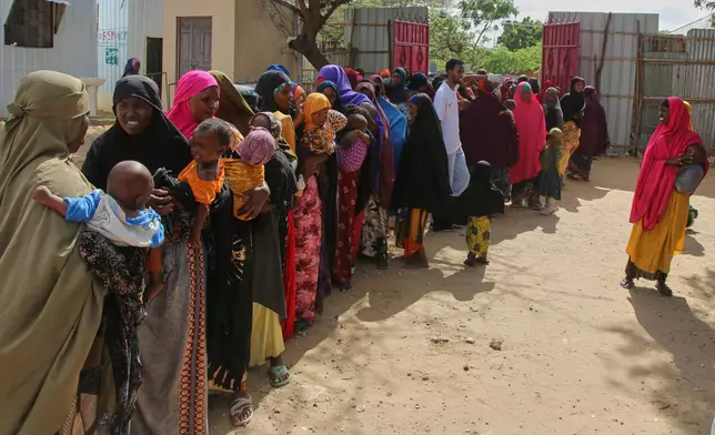 FILE - Somali women displaced by drought line up at Feynuus Nutrition Centre on the outskirts of the capital, Mogadishu, Somalia, Aug. 19, 2026. (AP Photo/Farah Abdi Warsameh, File)