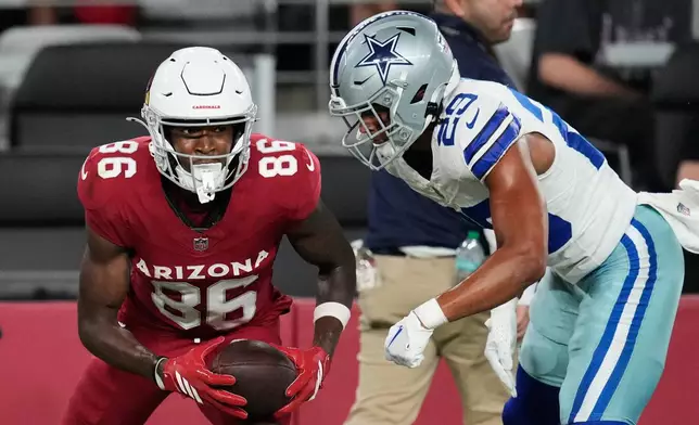 Arizona Cardinals wide receiver Jalen Brooks (86) celebrates his catch in front of Dallas Cowboys cornerback Devin Moore (29) in the first half of a preseason NFL football game Saturday, Aug. 22, 2026, in Glendale, Ariz. (AP Photo/Ross D. Franklin)