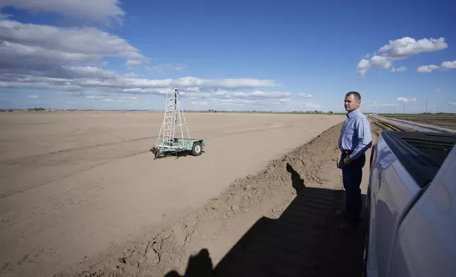 FILE - Tom Brundy looks over his field that is being prepared for planting near Calexico, Calif., Feb. 28, 2023. (AP Photo/Gregory Bull, File)