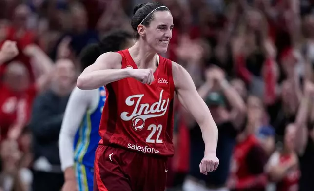 Indiana Fever guard Caitlin Clark celebrates after a 3-point basket against the Dallas Wings in the second half of a WNBA basketball game in Indianapolis, Friday, Aug. 14, 2026. (AP Photo/Michael Conroy)