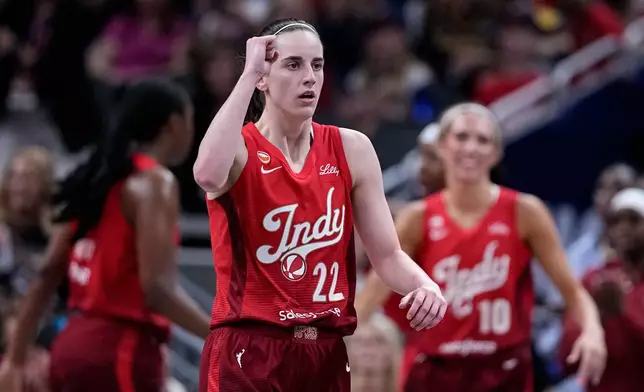 Indiana Fever guard Caitlin Clark (22) celebrates in the second half of a WNBA basketball game against the Dallas Wings in Indianapolis, Friday, Aug. 14, 2026. (AP Photo/Michael Conroy)
