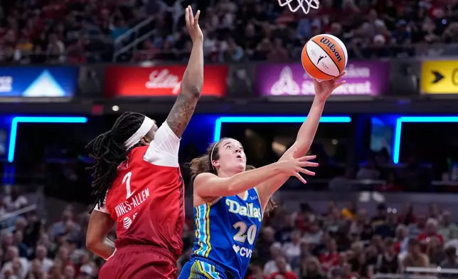Dallas Wings forward Maddy Siegrist (20) shoots in front of Indiana Fever forward Myisha Hines-Allen (2) in the second half of a WNBA basketball game in Indianapolis, Friday, Aug. 14, 2026. (AP Photo/Michael Conroy)