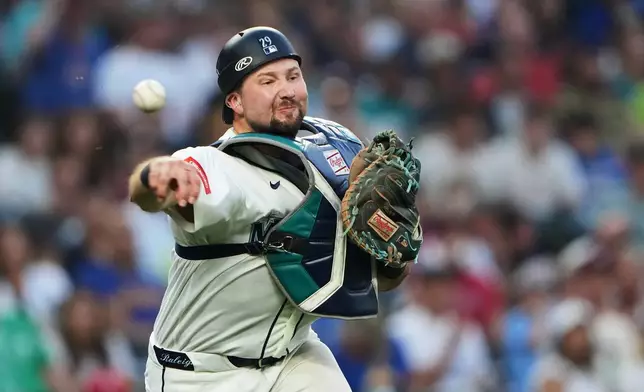 Seattle Mariners catcher Cal Raleigh throws to first for the out against Philadelphia Phillies' Trea Turner during the fifth inning of a baseball game, Tuesday, Aug. 25, 2026, in Seattle. (AP Photo/Lindsey Wasson)