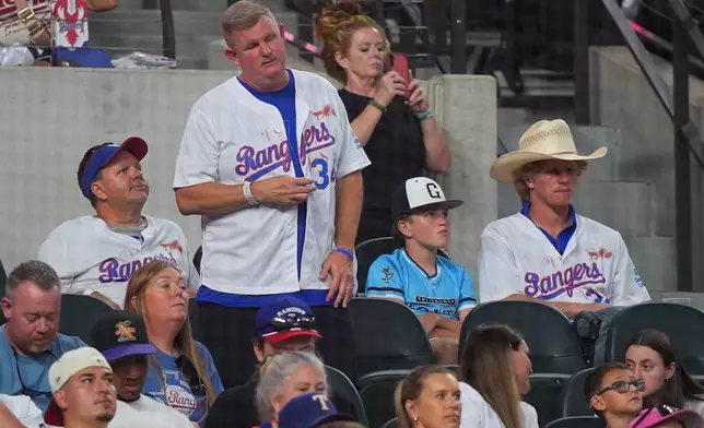 FILE - Texas Rangers fans in the stands wear Nolan Ryan jerseys during a baseball game against the Kansas City Royals, May 29, 2026, in Arlington, Texas. (AP Photo/LM Otero, File)
