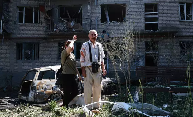 Residents look at their ruined home following a Russian air guided bomb strike in Zaporizhzhia, Ukraine, Monday, Aug. 10, 2026. (AP Photo/Kateryna Klochko)