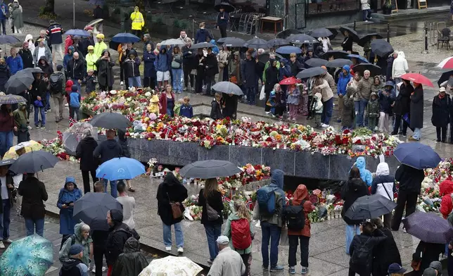 Flowers and cards laid at the Blue Stone in Bergen for Norway’s King Harald V on Saturday, Aug. 29, 2026. (Silje Katrine Robinson /NTB Scanpix via AP)