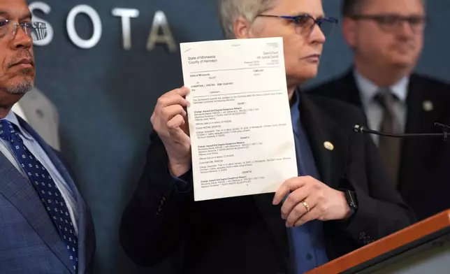 FILE - Hennepin County attorney Mary Moriarty holds up a document containing charges against ICE agent Christian Castro during a news conference at the Hennepin County Government Center in Minneapolis, on Monday, May 18, 2026. (Renée Jones Schneider/Minnesota Star Tribune via AP,File)